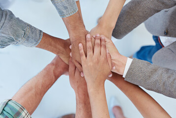 United in business we stand. Shot of a group of coworkers with their hands in a huddle.