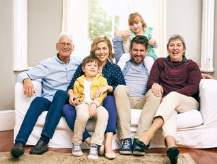 There is no love like the love of a family. Shot of a multigenerational family sitting on the sofa at home.
