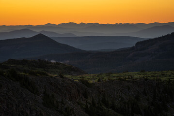 sunrise overlooking layers of mountains