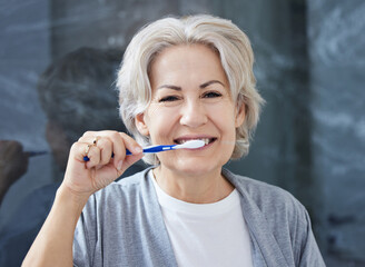 I still have all my teeth because I take good care of it. Shot of a senior woman brushing her teeth...