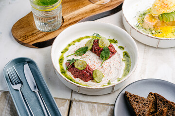 Veal tartar with truffle sauce and pickled cucumber