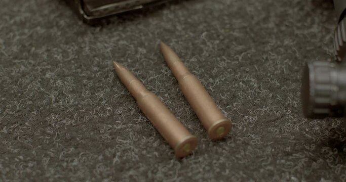Close-up of firearm ammunition on gray background. Armament engineering is the design, development, testing of military weapons.