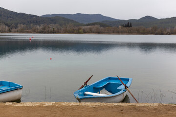 Old blue rowboat at the lake shore in Banyoles, Catalonia