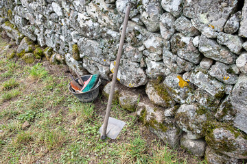 tools leaning against a wall in an archaeological excavation