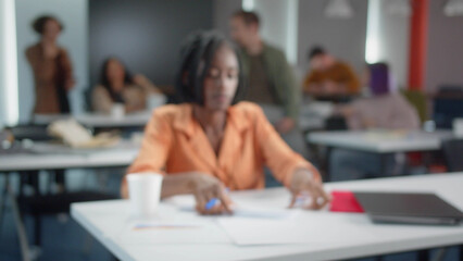 An attractive young african professor is preparing for the seminar, defocused video
