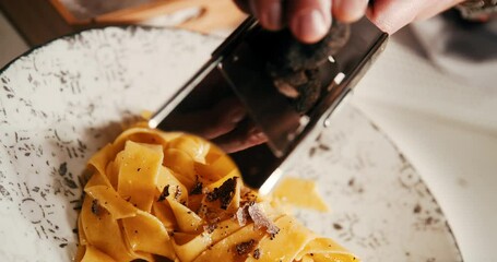 Chef cooking and serving pasta in fine dining restaurant. 