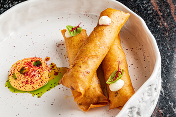 Deep fried popiah popia roll wraps with dipping sauce.