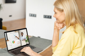Senior female working or studies online. Mature woman is watching online classes. Concept of...