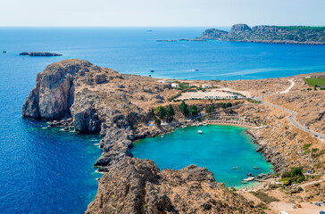 Fototapeta na wymiar The St. Paul's Bay in Lindos, in the island of Rhodes, Greece. Photo taken from the Acropolis of Lindos.
