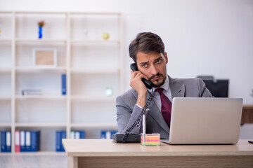 Young male employee working in the office