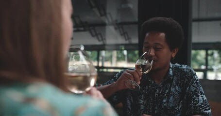 Young couple on a date clinking wineglasses
