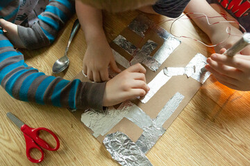 Children's Hands Holding Batteries During Group Science Experiment