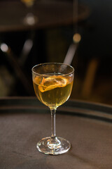 Yellow transparent cocktail in a glass with citrus