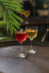 Transparent cocktails in glasses. Red and yellow cocktail at the bar