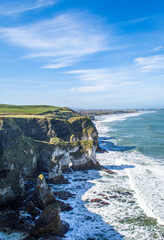 Famous white rocks at the coastline near Portrush Northern Ireland in a sunny day.