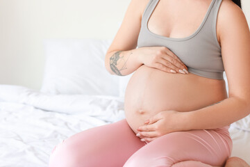 Fototapeta na wymiar Young pregnant woman resting at home