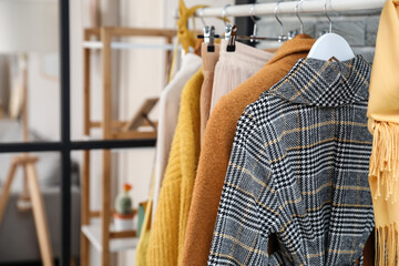 Rack with stylish clothes in modern studio of fashion stylist