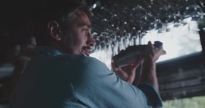 Caucasian bartender shaking cocktail