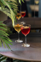 Transparent cocktails in glasses. Red and yellow cocktail at the bar