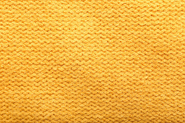 Texture of yellow knitted clothes, closeup