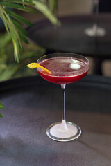 Transparent cocktails in glasses. Red and yellow cocktail at the bar