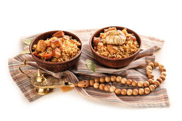 Bowls with tasty Asian pilaf on white background