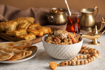 Traditional Eastern dishes with tasbih on table