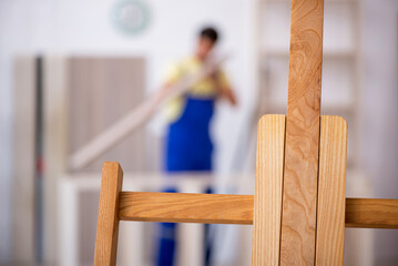 Young male carpenter working at workshop