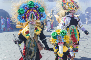 Obraz na płótnie Canvas A participant in Carnival in Huejotzingo wearing traditional dress dancing.