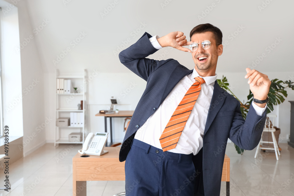 Sticker dancing young businessman in office