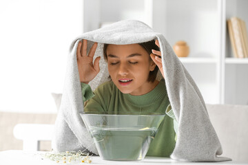 Young woman doing steam inhalation at home to soothe and open nasal passages - obrazy, fototapety, plakaty