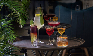 Transparent cocktails in glasses. Red and yellow cocktail at the bar