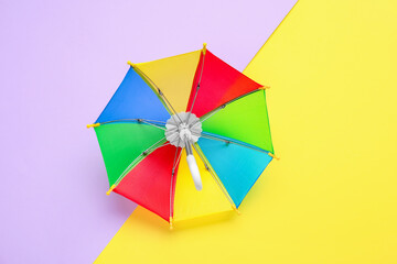 Open umbrella on color background