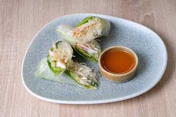 Rice paper pancakes with vegetables on a plate and sauce