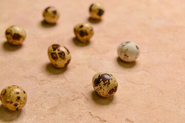 Fresh quail eggs on beige background