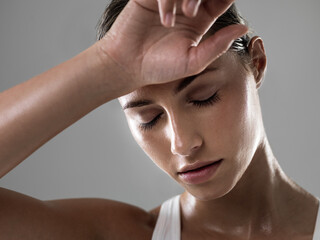 Total exhaustion, the sign of a great workout. Shot of an attractive woman looking tired after a good workout.