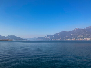 Fototapeta na wymiar Bergamo, Italy: 10-02-2022: Panoramic of Lake Iseo, the fourth largest lake in Lombardy, Italy, fed by the Oglio River.