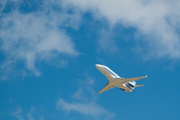 Blue And White Private Jet Take Off Underneath