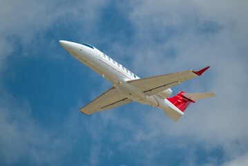 Small Private Jet Taking Off With Clouds And Blue Sky