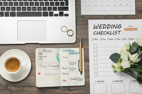 Flat lay composition with Wedding planner and checklist on wooden table
