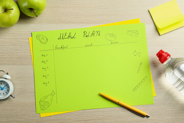 Flat lay composition with Meal Plan on wooden table
