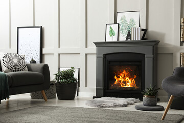 Stylish living room interior with electric fireplace and comfortable furniture