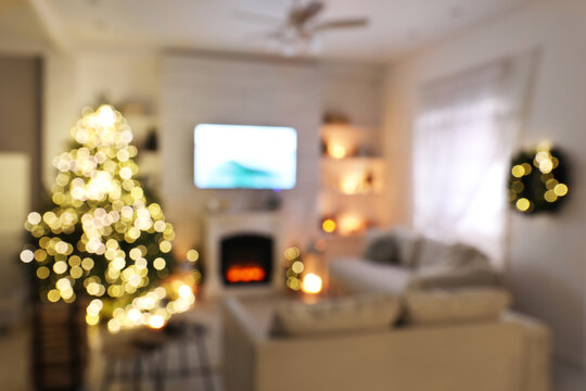 Blurred View Of Stylish Living Room Interior With Decorated Christmas Tree And TV Set