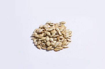 Heap of pumpkin seeds isolated on white background