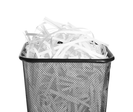 Trash bin with shredded paper strips isolated on white