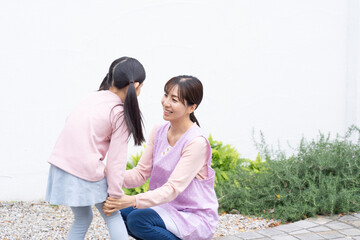 保育園の先生と話す園児（育児・子育て・教育）