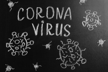 Word Coronavirus written on blackboard, top view