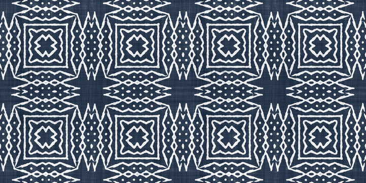 Seamless tribal ethnic indigo blue batik surface design pattern on rough linen, a trendy contemporary tileable abstract geometric shibori textile for interior decor and fashion.