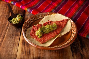 Tacos de Cecina Enchilada con Guacamole. Salted, sun-dried pork or beef meat, seasoned with various spices and chili peppers, usually eaten in tacos