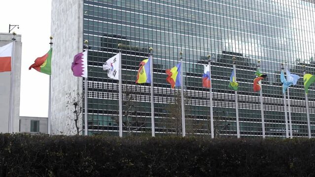 South Korea, Romania and Russian flag flying slow motion in the wind. United Nations headquarter Building